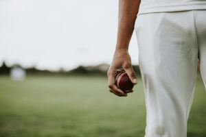Cricket player holding a leather ball