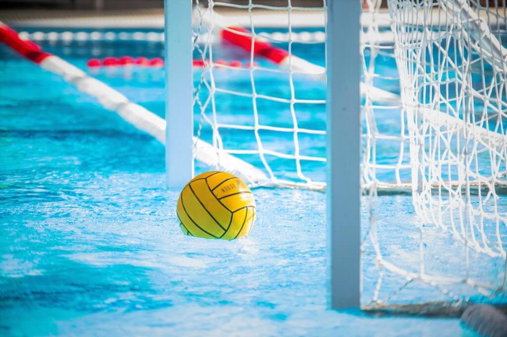 Yellow water polo ball in the pool