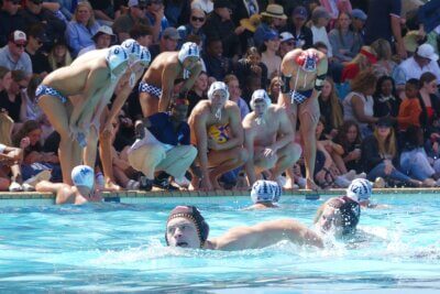 SA Schools' coach Jabulani Sibiya advises his Western Province team, which produced six SA Schools players, during the final, while Central Gauteng's Greg Pryce, the Defender of the Tournament, swims past in the foreground.
