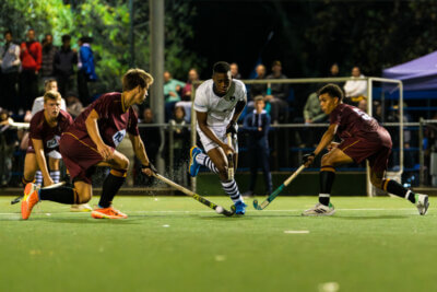SACS's Litha Kraai charges in between two PRG players during their encounter at the Brewery Astroturf in Cape Town on 10 May 2024. Photo Credits: Ray Chaplin
