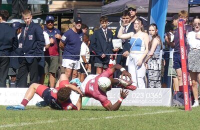 KES wing Hankiel Monkoti, with Evan Moolman hanging onto him, extends to ground the ball for the first of six KES tries. 