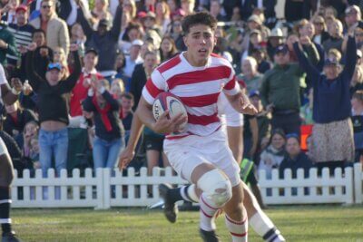 Michaelhouse supporters throw their hands in the air in celebration as Rourke O'Sullivan crosses for Michaehouse's second try.