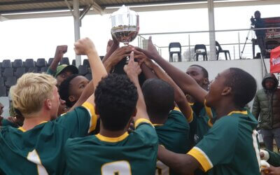 Glenwood's players reach for the Primo Big 10 trophy after they won the title with a hard-fought victory over DHS.