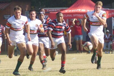 Maritzburg College centre Nkululeko Sithole is pursued by Affies' defenders as he kicks ahead on Goldstone's.