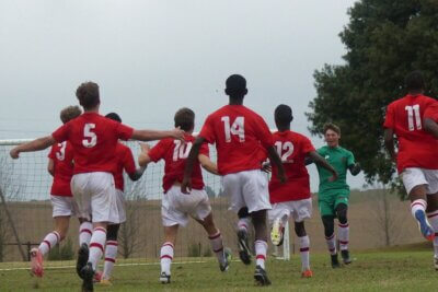 Michaelhouse players charge towards goalkeeper Luke Mitchell after clinching a penalty shootout victory over Ixopo High School in the final of the Jody Momple Cup.