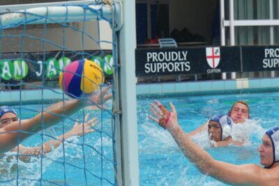 SACS' defenders, Zac Cicero and Nicholas Fall, glance nervously behind them as goalkeeper Leo Jackson's outstretched arm deflects a goal-bound St John's shot into the post. The ball stayed out.