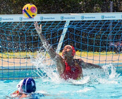 Kuhle Zulu stretches high to pull off a save for the Central Gauteng u16 team at the Schools Water Polo South Africa Inter-Provincial Tournament in East London in December 2024. Photo: Will Morrell.