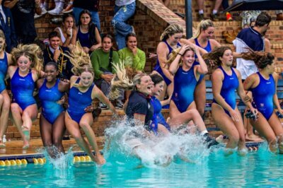 Coach Megan Sileno and her St Stithians team celebrates winning the Reef Cup with the traditional plunge into the pool. Photo: Debbi Adcock Photography.
